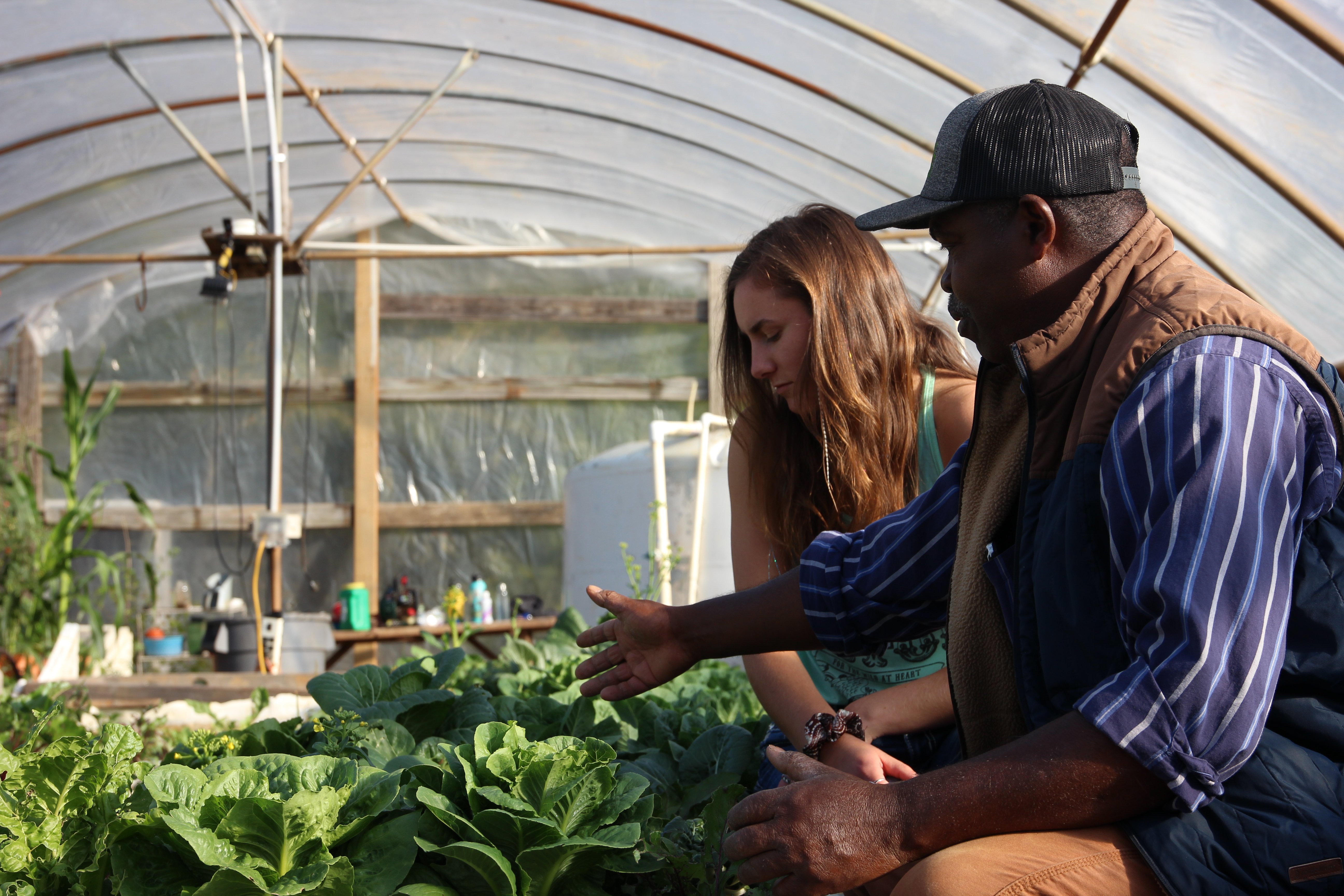 agthech girl and guy looking at plants